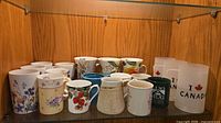 Full shelf view of assorted mugs showing quantity and variety
