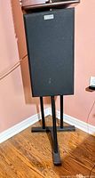 Front view of Nuance floorstanding speaker on stand with grille attached