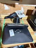 Pressure cooker, roasting pan lid, wire fry basket and manual on countertop
