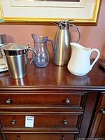 Group shot of stainless carafe, ice bucket, glass pitcher, ceramic pitcher