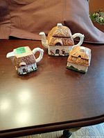 full set of three cottage-shape ceramic pieces on table