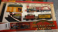 Retail box showing locomotive, cars, station, track inside