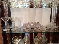 Group view of martini glasses, small bowls, shakers basket, covered butter dish