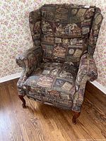 Front view of wingback chair showing upholstery pattern, arms, legs, cushion