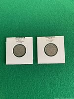Two 1922 Canada 5-cent coins in flips on green background