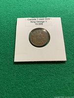 Coin in 2×2 flip with label "Canada 1 cent 1929 King George V 10.00$" showing reverse side