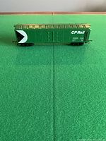 Side view of green CP Rail HO boxcar #81030 on green surface