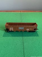 Side view of brown Frisco SL-SF 31722 coal hopper car on green surface