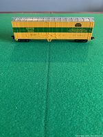 Side view of yellow/green NYMX 1020 mechanical refrigerator car