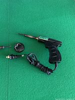 Pistol-grip soldering gun, round accessory, cord detail