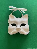 Front view of white cat mask with ribbons