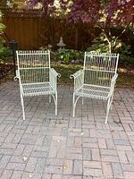 Front view of two cast aluminum chairs on patio