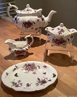 Full tea set showing teapot, creamer, sugar bowl and plate