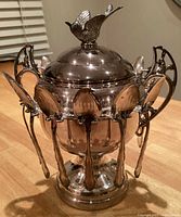 Front view of silverplate caviar urn with spoons attached