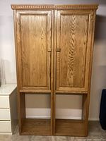 Front view of both oak cabinets with doors closed