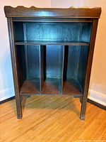 Front view of cabinet showing top shelf and three-slot lower section