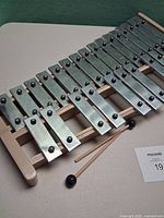Full view of aluminum xylophone with mallets