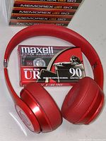 Beats Solo headphones with Maxell UR 90 cassette and stack of Memorex dB 90 tapes