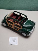 Front side view of green woody convertible car