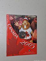 Front of sealed RCM card with 2005 quarter visible