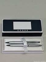 Closed Cross presentation box displayed above open insert showing silver pen and pencil