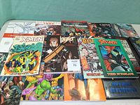 All graphic novels laid out face-up for cover identification