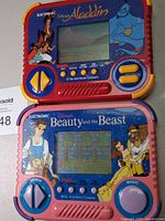 Front view showing both Disney Tiger handheld games: Aladdin (top) and Beauty and the Beast (bottom)