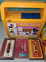 Front view of Mickey Mouse cassette player with three cassettes