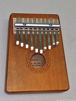 Front view showing 10 metal tines and engraved rosette