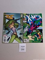 Both comic books side by side showing covers and lot tag