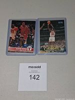 Both cards in protective sleeves side by side