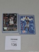 Both Michael Jordan cards side by side in sleeves