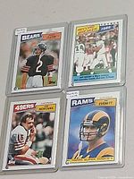 Overall view of four Topps NFL quarterback cards in plastic holders