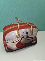 Front view showing Cortez shoe graphic and gold handles