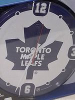 Front view of clock showing logo and numerals