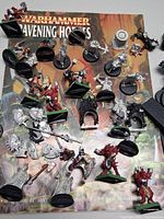 Overall lot showing book, many miniatures, bases scattered