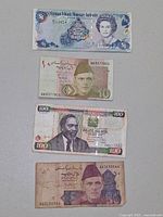 Front sides of four banknotes displayed vertically