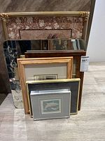 Group view showing all framed pieces, mirror and empty frame