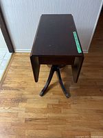 Table with leaves down showing drawer and pedestal base