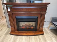 Front view of fireplace showing full wooden mantel and firebox
