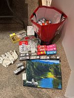 Tote with golf balls, tees, gloves, towel, boxes, sleeves visible