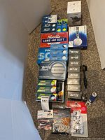 Full view of golf ball boxes, tees, tools and colognes laid out