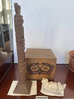 Wood totem, wood box with Indigenous artwork, marble otter together