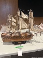 full view starboard side showing hull, masts, sails and stand with scale label