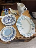 Group shot of all eight ceramic pieces on wicker surface