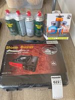 Overall lot showing stove, four butane cans, Pinnacle Dualist cook set