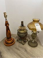 three lamps grouped: wood, metal, amber glass