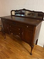 Full front view of sideboard showing mirror, drawers, doors, cabriole legs