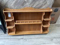 Full view of wooden wall display shelf unit