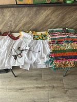 Overall shot: two blouses, poncho, two necklaces, cuff bracelet